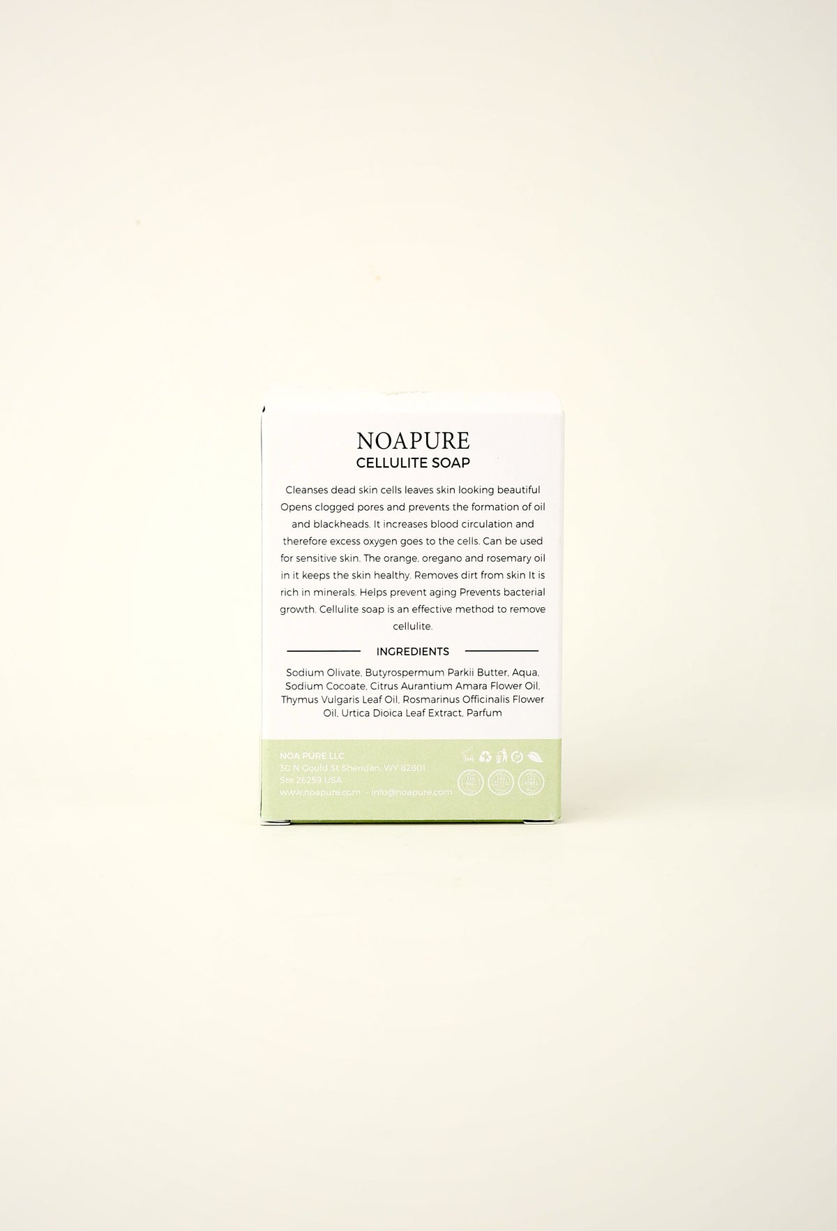 NoaPure Exfoliating Body Ritual Bar packaging in white and pale green on an off-white background