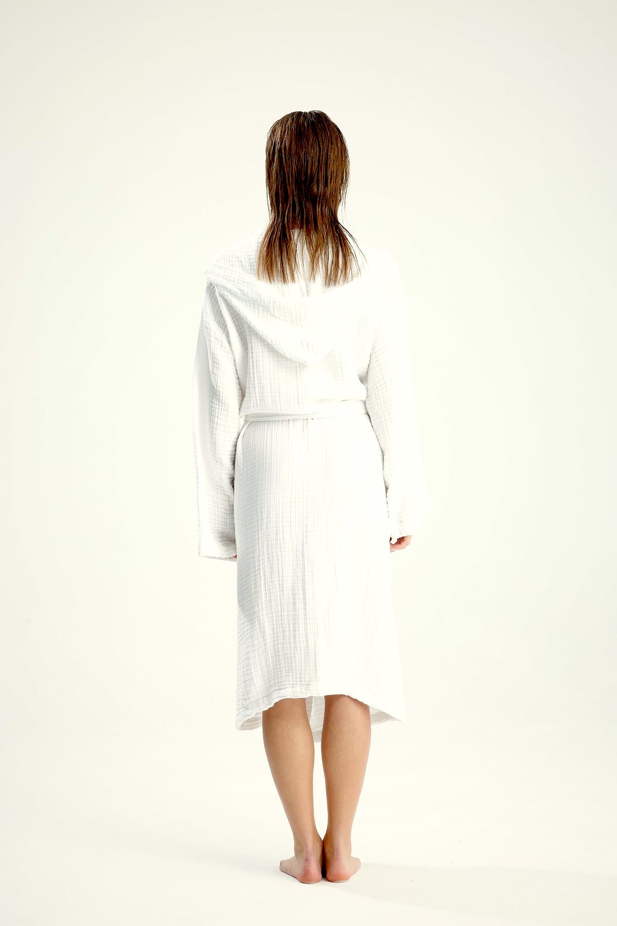 Back view of a white muslin cotton hooded bathrobe with tie belt